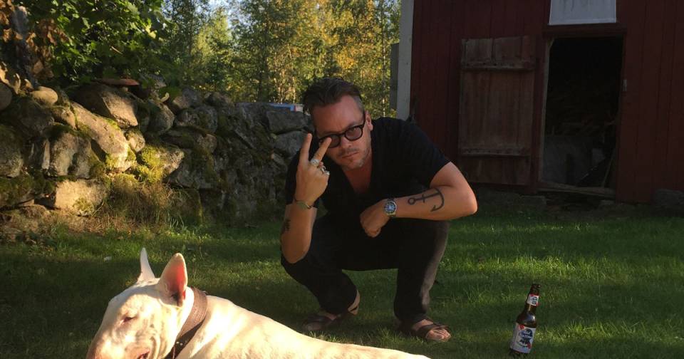 Anders Jedenfors being cool with his dog and an ice cold beer. Do you see the anchor tattoo? I bet that means something.
