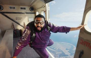DJ Khaled wearing a purple jump suit as he gets ready to sky dive out of a plane.