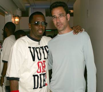 P Diddy and MTV News Executive Producer Dave Sirulnick are standing next to each other at an election party